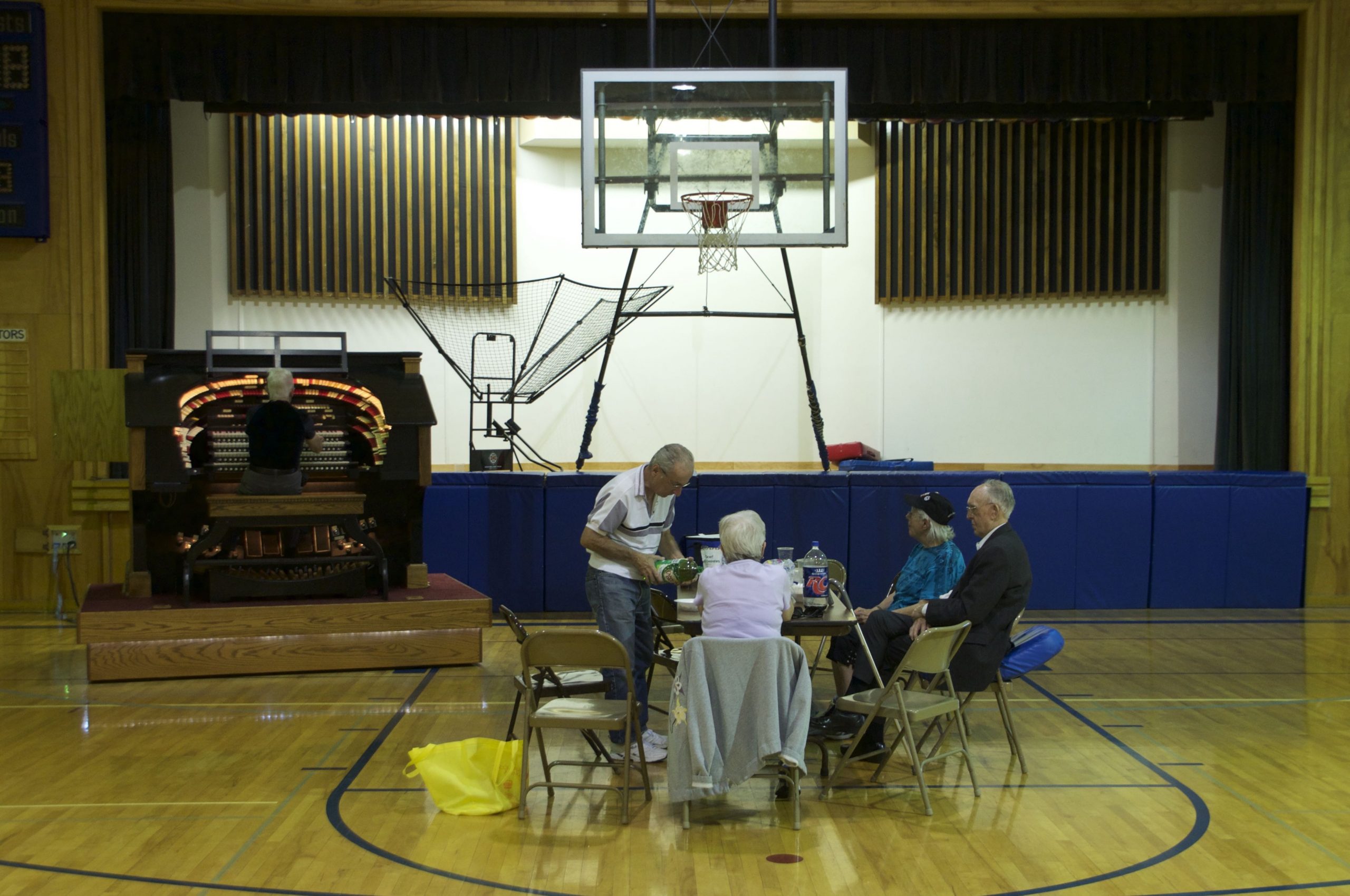 Attendees at the theater organ society monthly meet-up enjoy refreshments as Keith Roberts plays the organ.