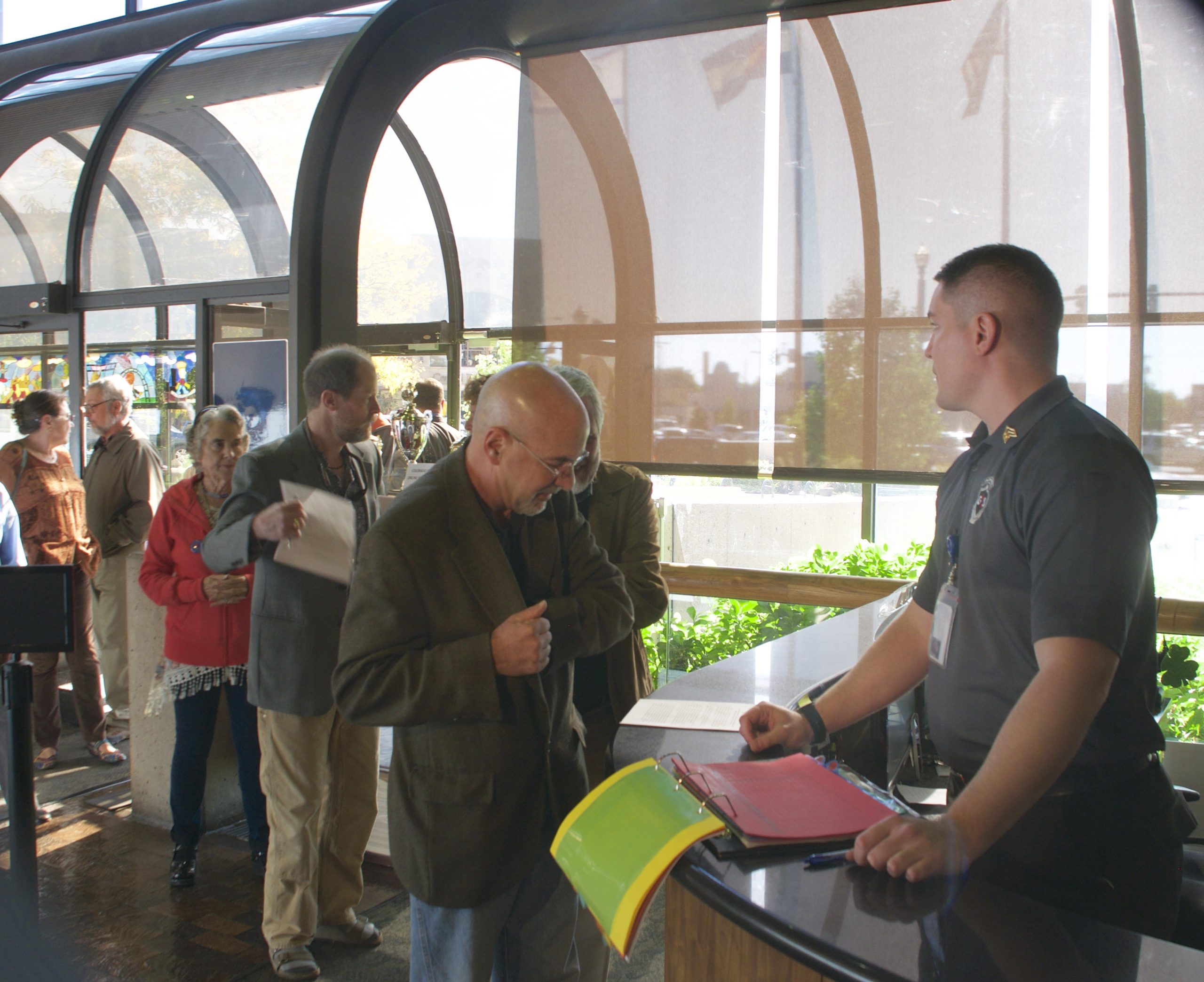 Colorado Springs residents, led by Richard Skorman, sign in at the Colorado Springs city administration building, where they began the process to get a initiative on next April's ballot to require voter approval of city parkland sales and transfers.