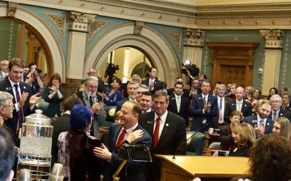 Colorado Gov. Jared Polis is embraced by his mother before his State of the State address on Thursday morning.