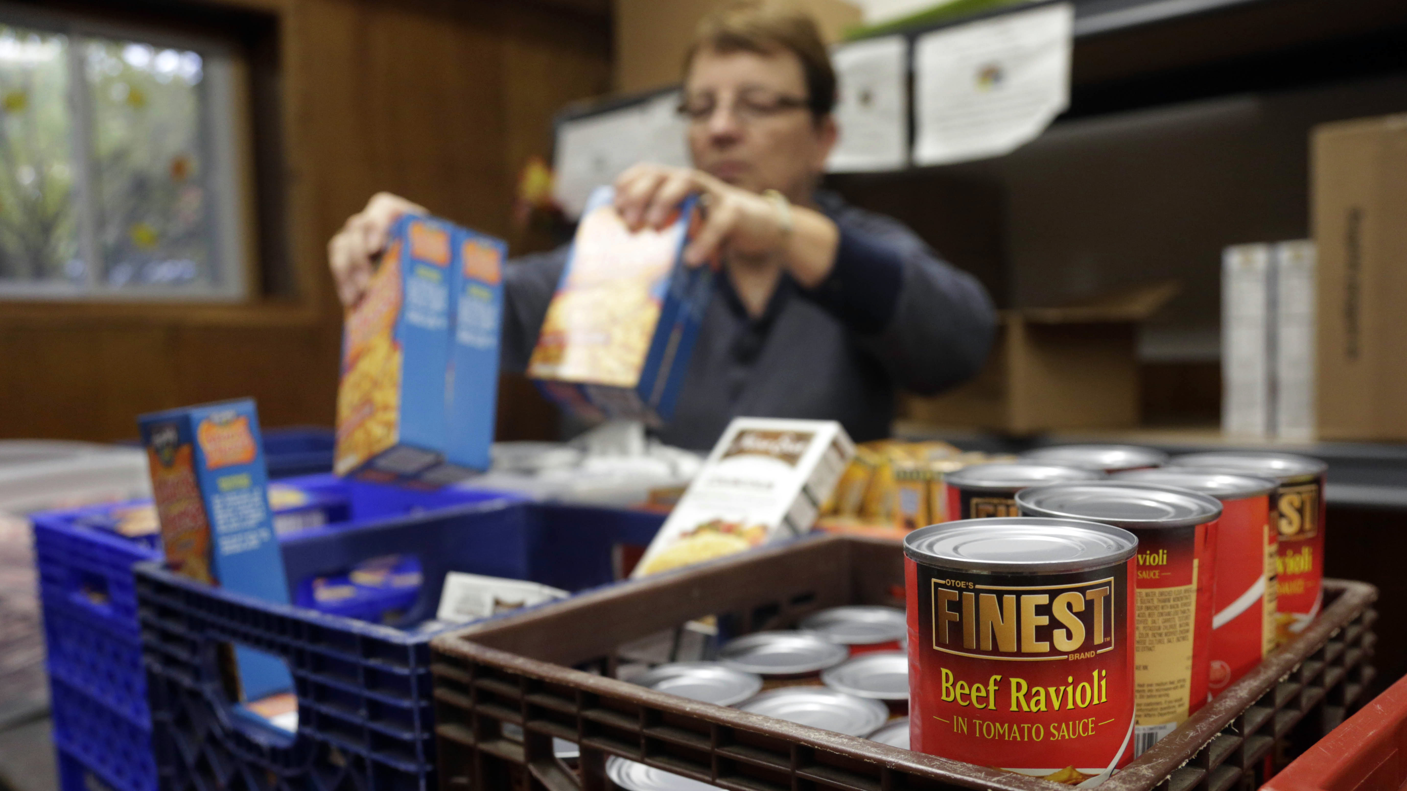 Photo: Volunteer stocks food shelf