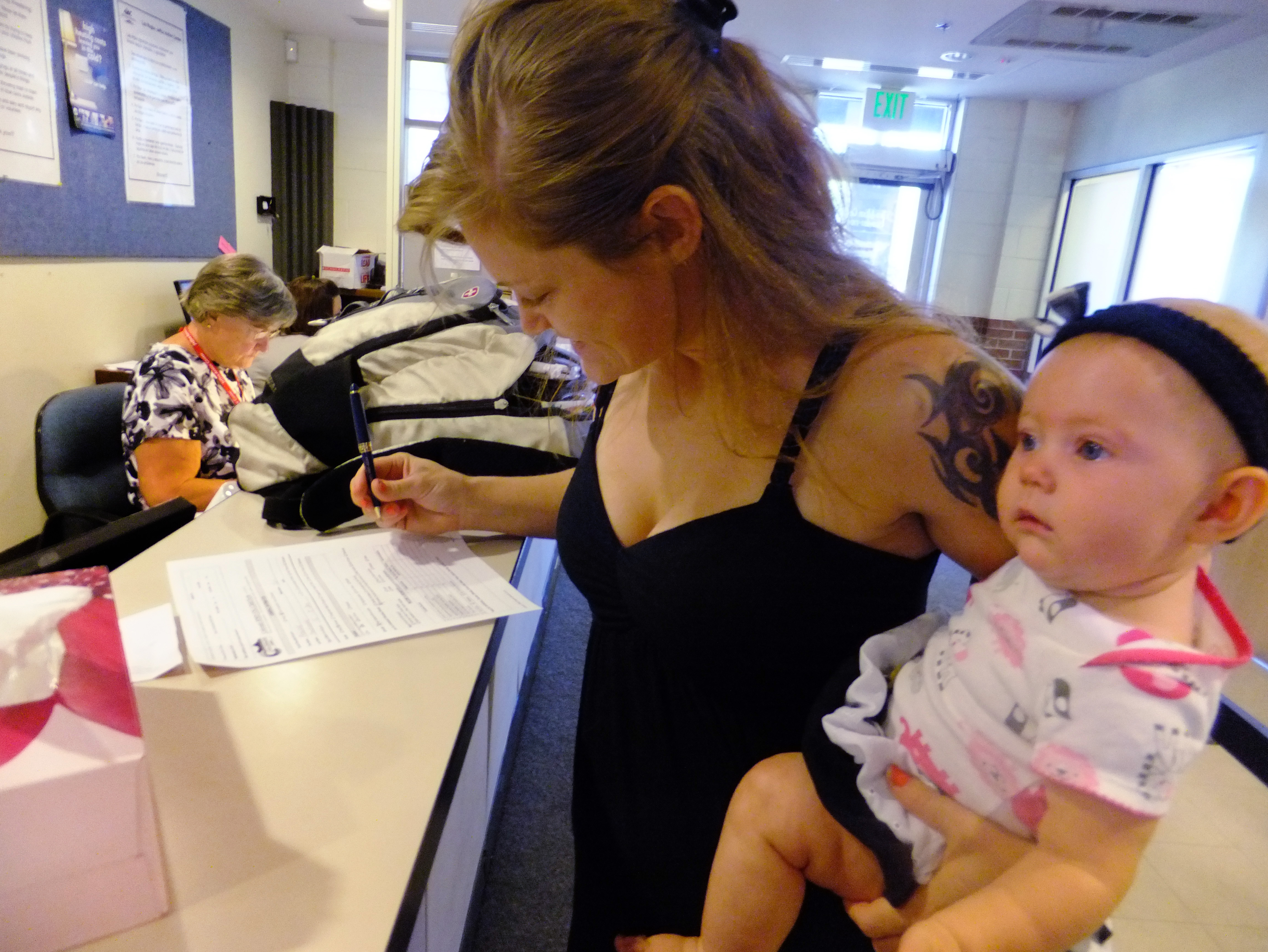&lt;p&gt;In this July 16, 2012, photo, Laura Fritz, 27, left, with her daughter Adalade Goudeseune fills out a form at the Jefferson Action Center, an assistance center in the Denver suburb of Lakewood.  Fritz grew up in a solidly middle class family, but she and her boyfriend, who has struggled to find work, and are now relying on government assistance.&lt;/p&gt;