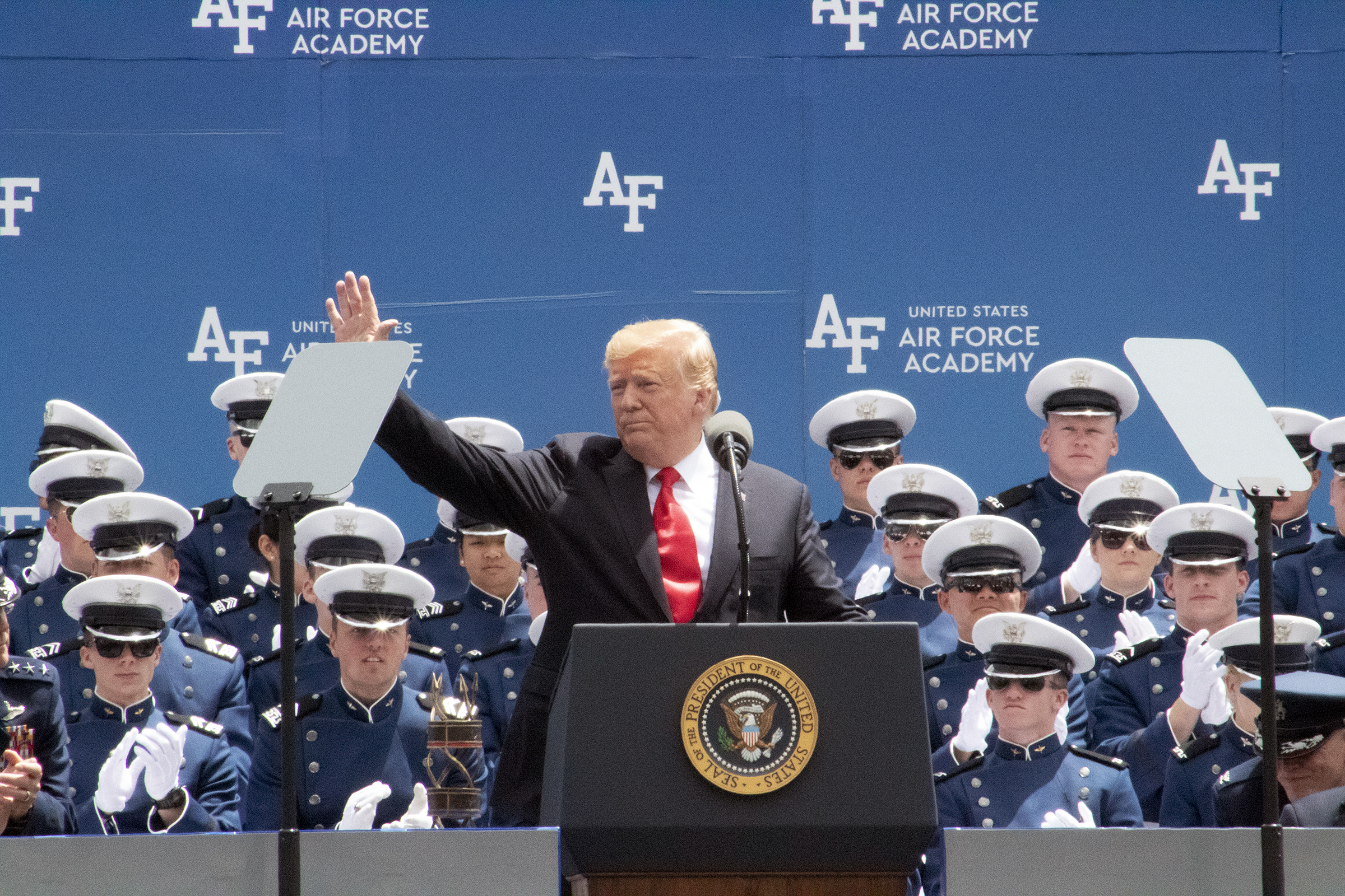 President Donald Trump waves to the crowd as he begins his address.