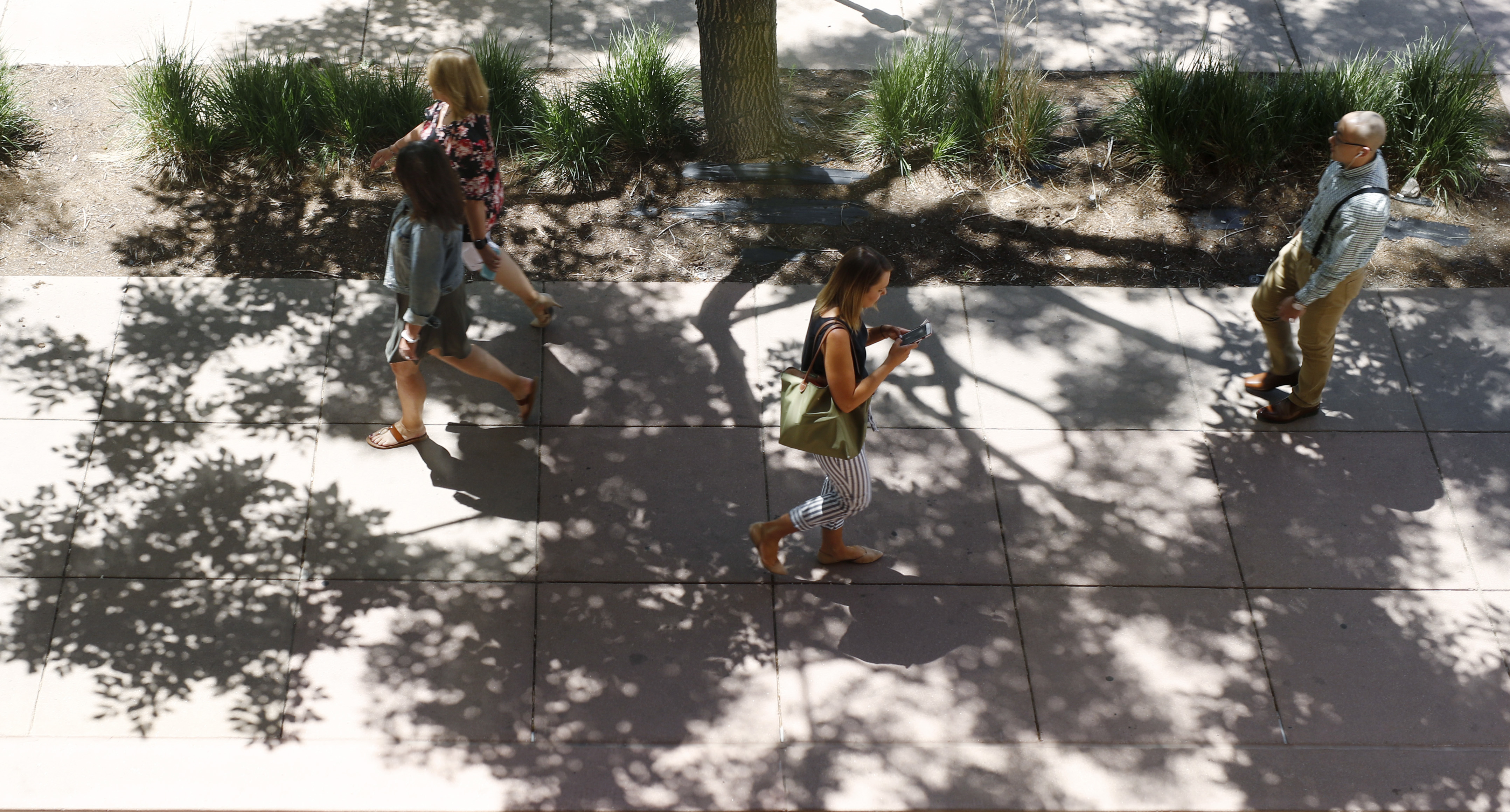 Photo: Denver weather sidewalk pedestrians (AP Photo)