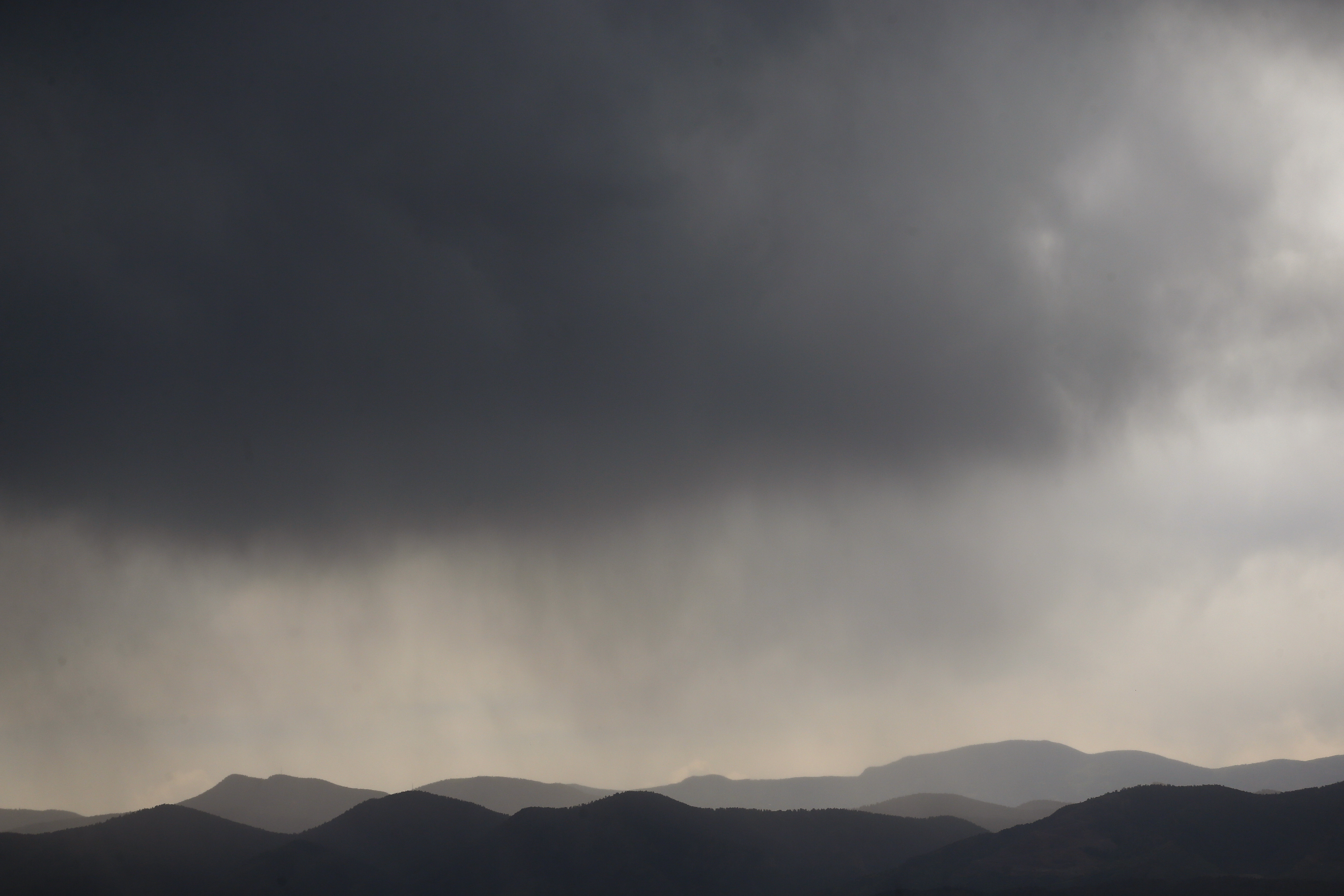 Photo: Storm clouds over the Rockies (AP Photo)