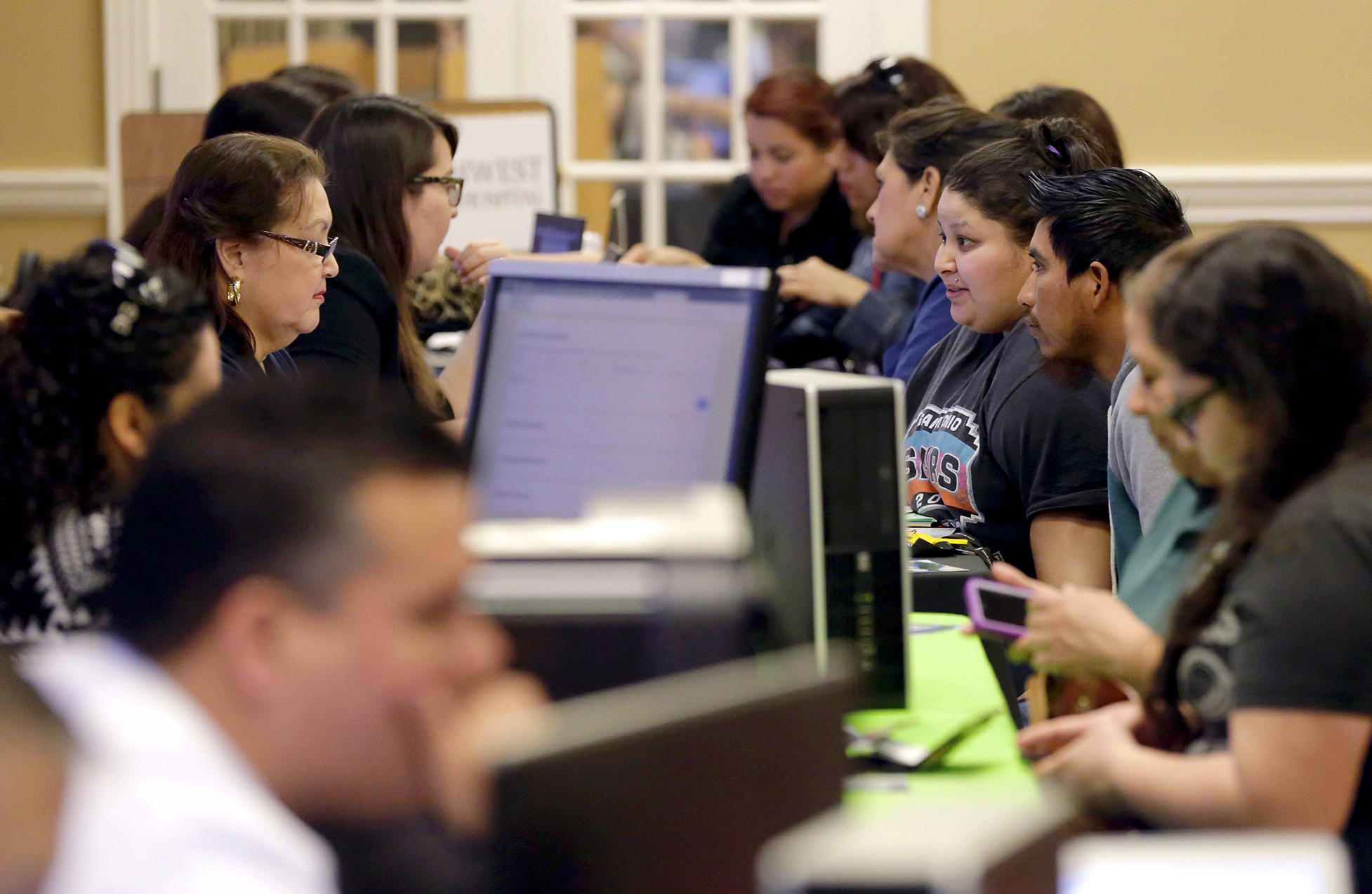 Affordable Care Act navigators helped guide those looking for insurance during an enrollment event at San Antonio's Southwest General Hospital last year. Beyond helping with initial enrollment, navigators often follow-up with help later, as an applicant's income or job status changes.