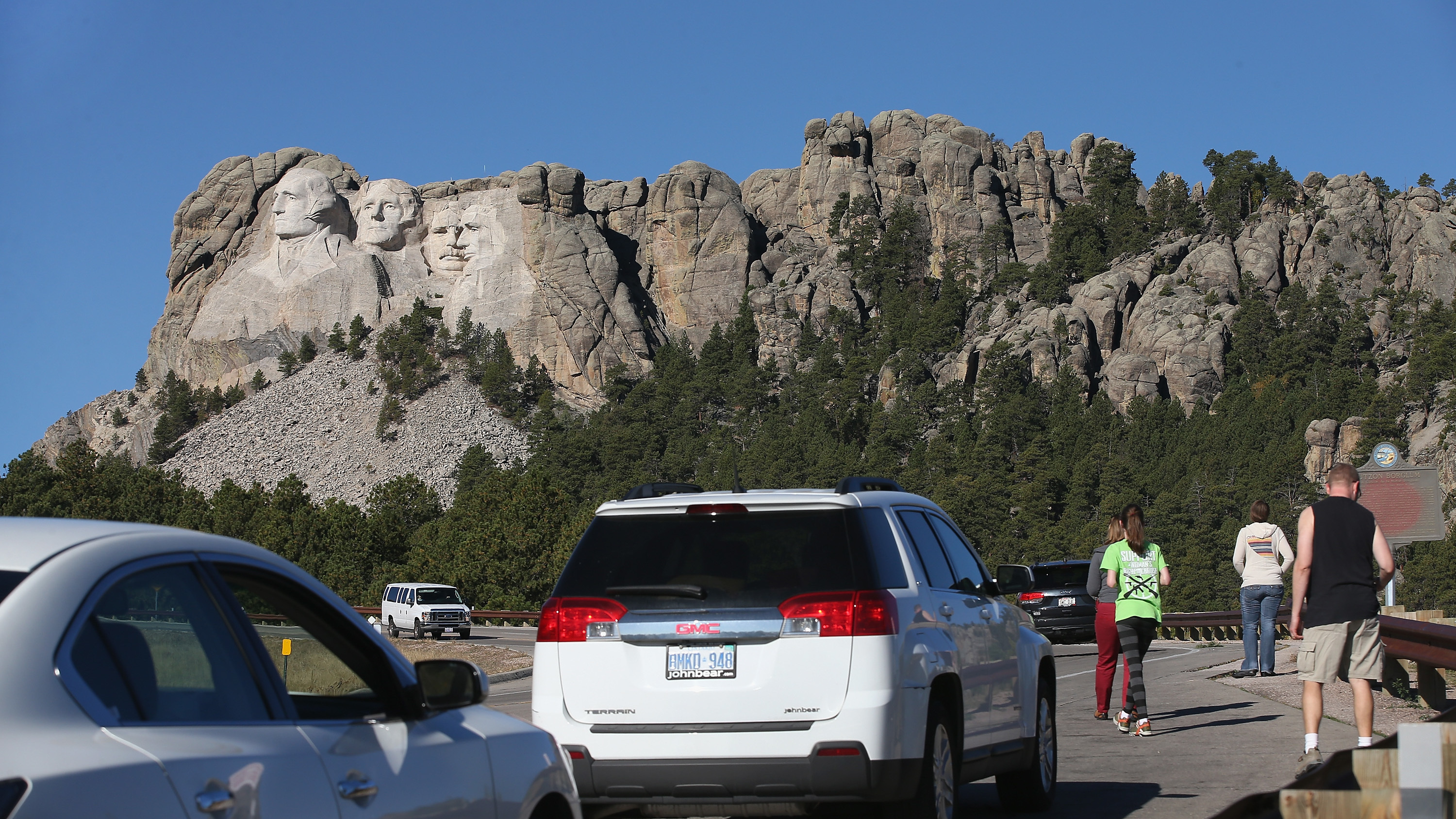 During the 2013 shutdown, tourists have to look at Mount Rushmore from the highway because the national memorial in Keystone, S.D., was closed.