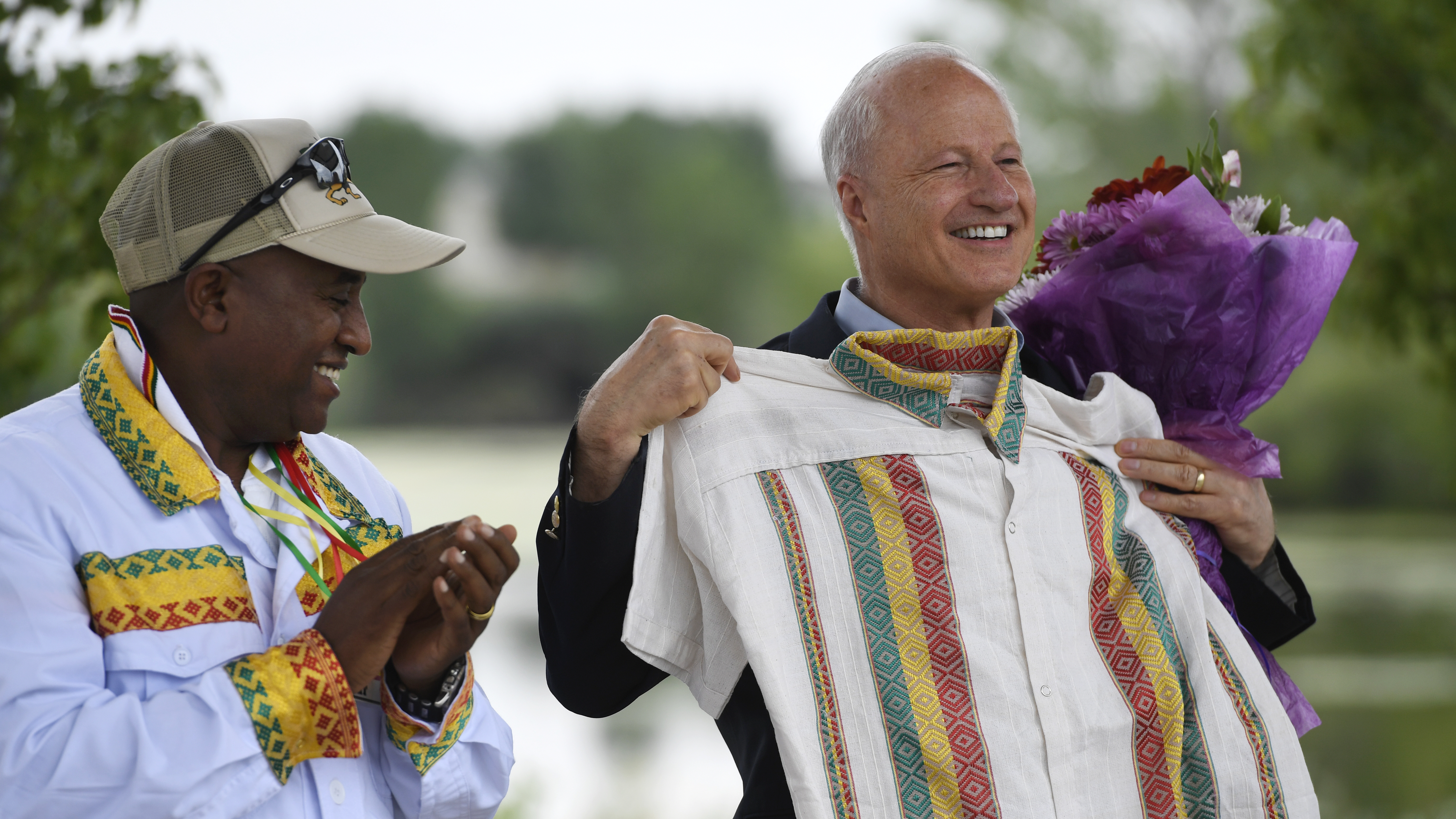Then-U.S. Rep. Mike Coffman accepts a gift of a traditional Ethiopian shirt from Girum Alemayehu at an Ethiopian festival in Denver in August 2016. Coffman is waiting to hear election results from 2019 to hear if he will be Aurora's next mayor.