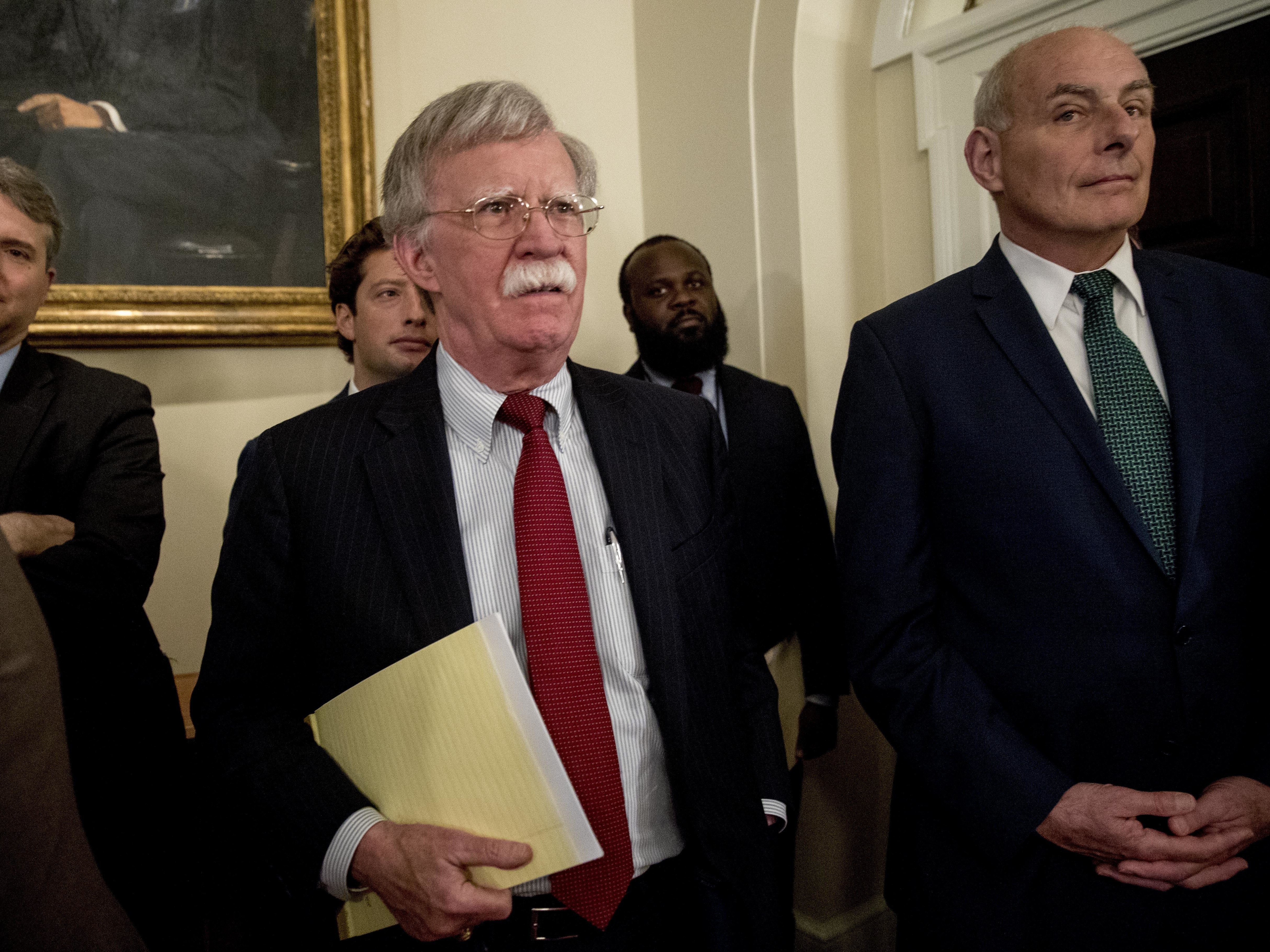 National security adviser John Bolton, center, and President Trump's chief of staff John Kelly, right, attend a Cabinet meeting in the White House, Tuesday, last month.