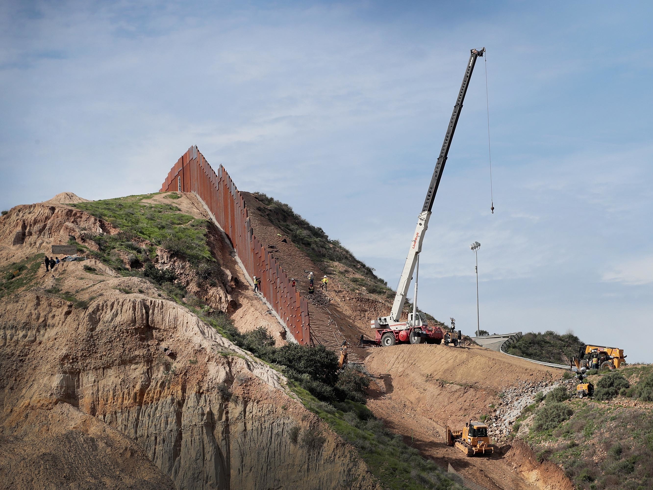 A section of border wall separates Tijuana, Mexico, from San Diego, as seen from the U.S. in January. California has filed a lawsuit along with 15 other states, calling President Trump's use of a national emergency declaration to redirect money toward border wall construction unconstitutional.