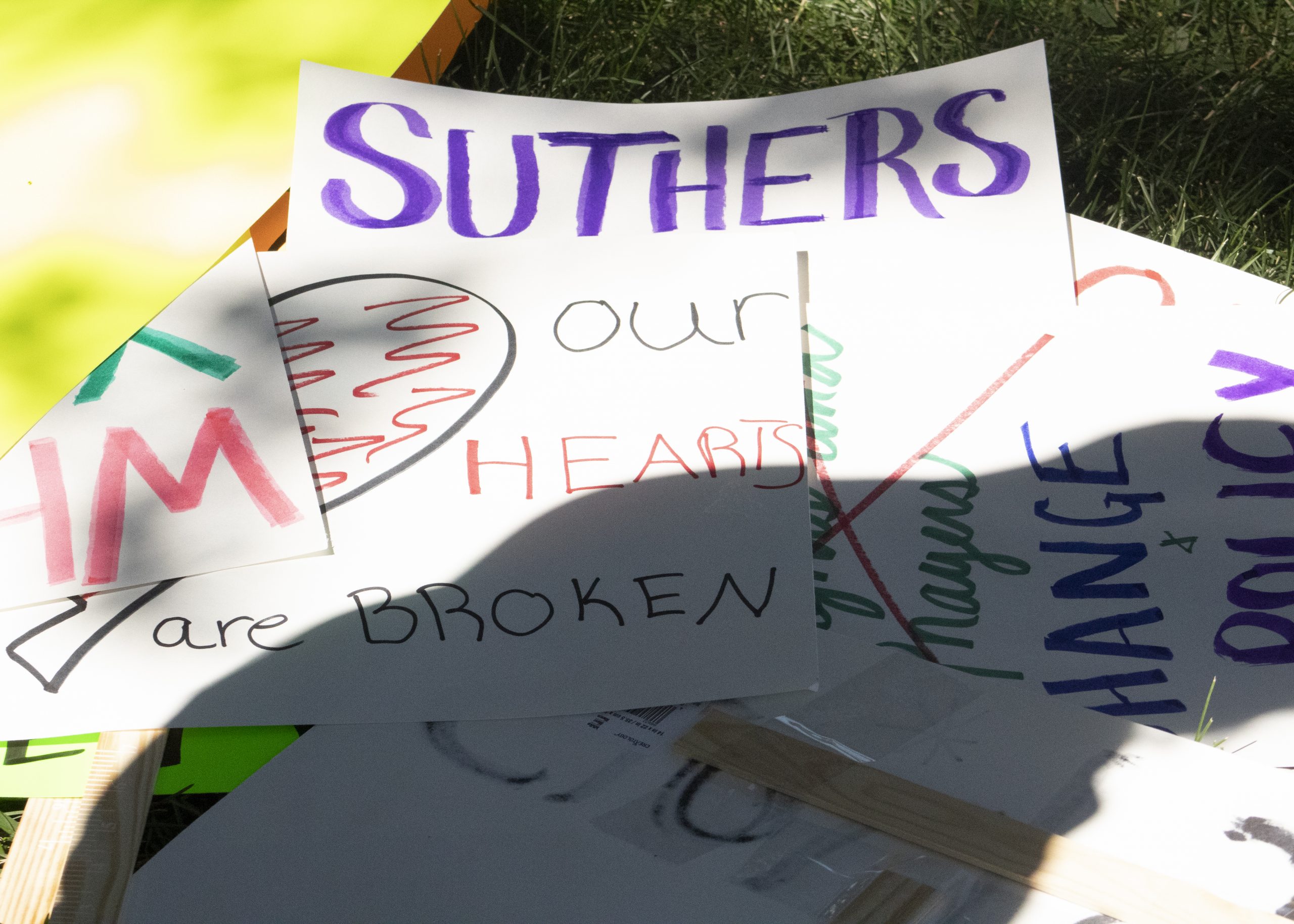 Signs at the press conference showed solidarity with the Bailey family and called out a lack of confidence in Mayor John Suthers.