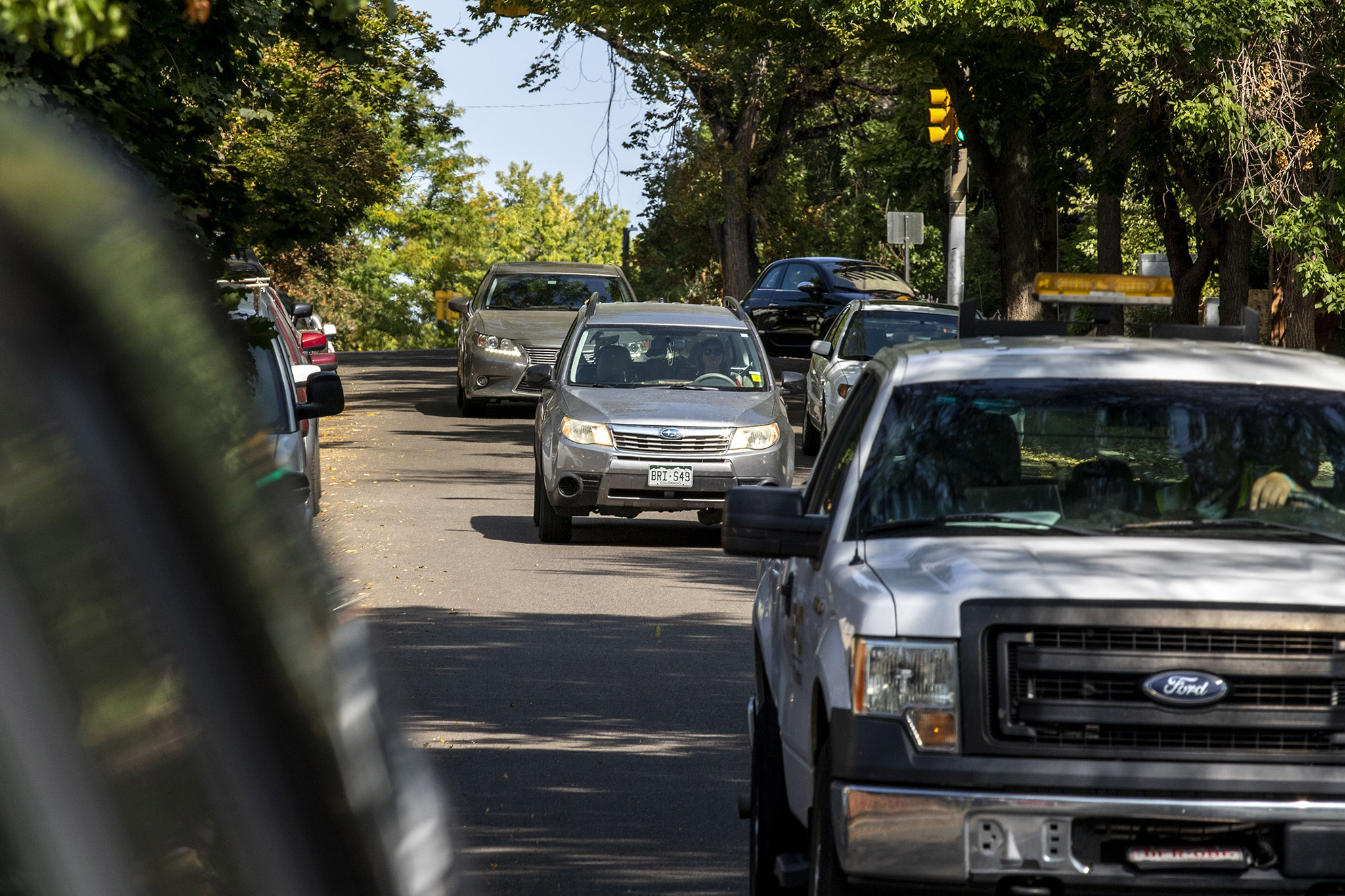 An SUV drives down Washington Street in Denver's Capitol Hill neighborhood. Sept. 28, 2021.