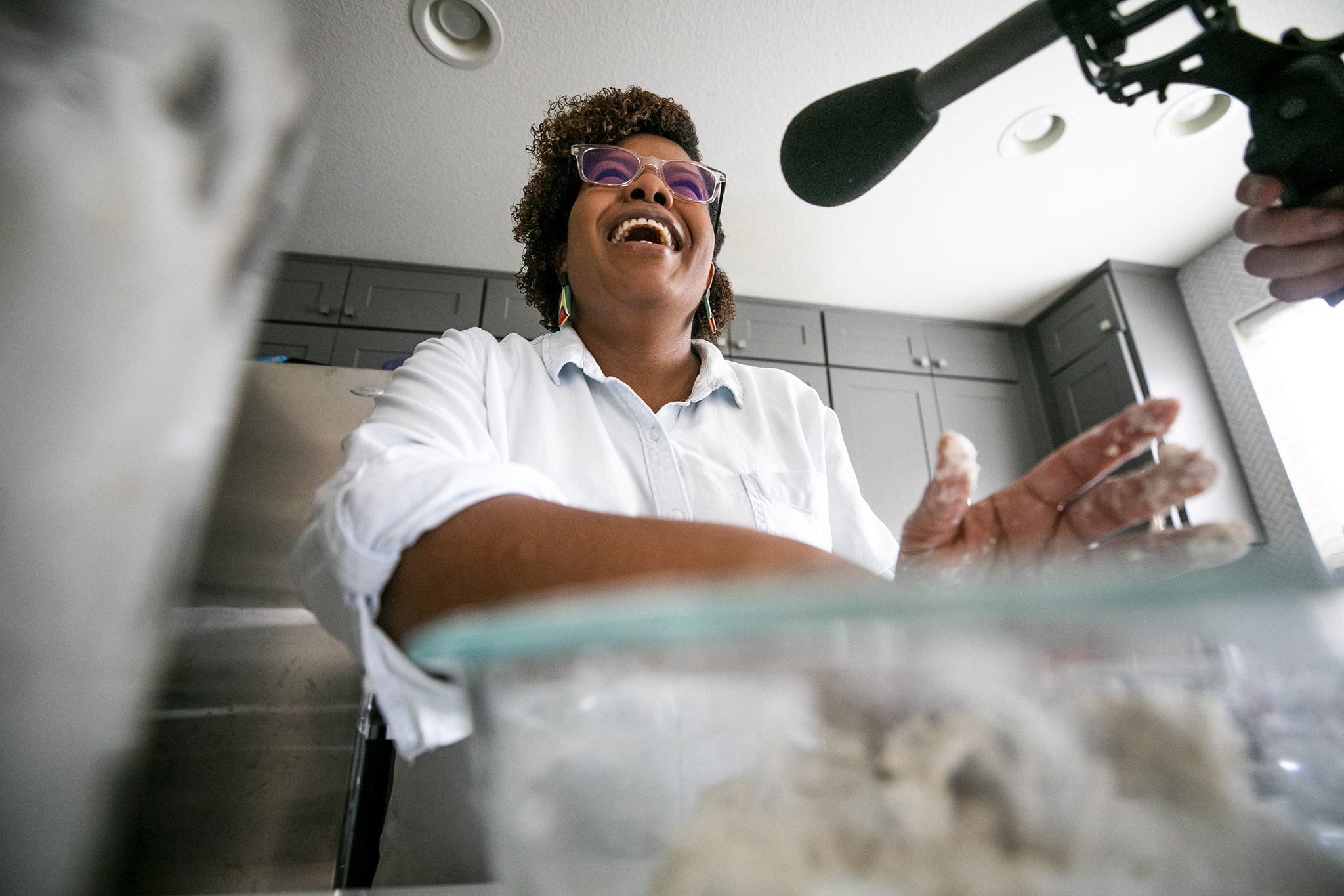 Althea Brown kneads roti dough in her Aurora home. Dec. 13, 2023.
