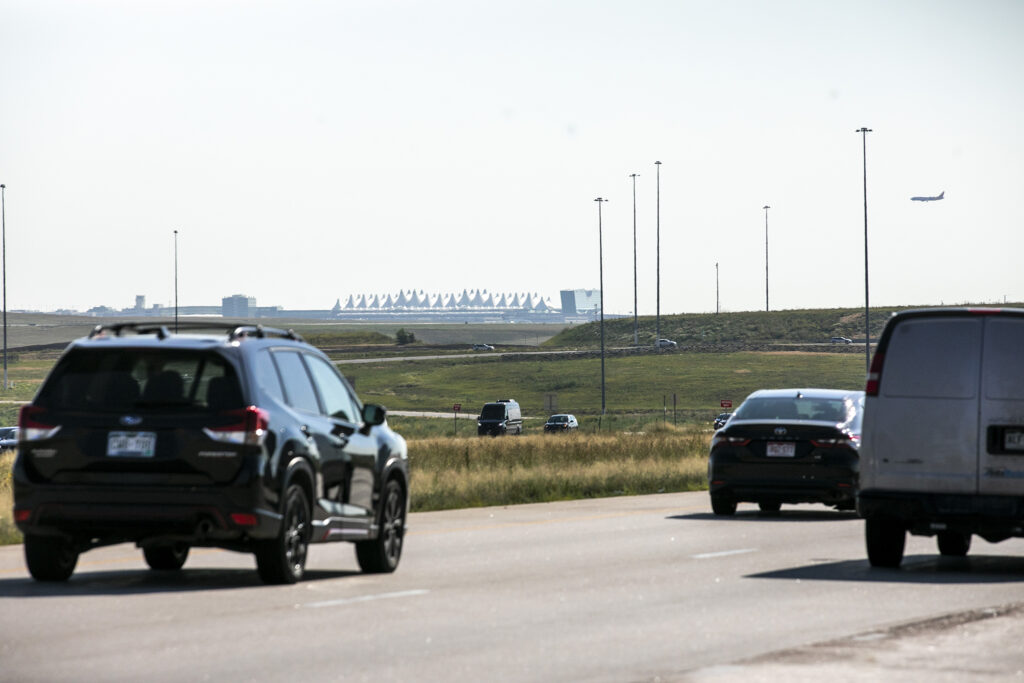 Cars drive over Peña Boulevard. Aug. 24, 2023.