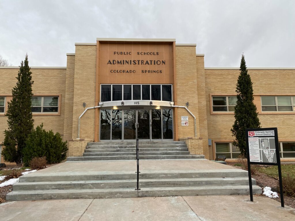 A modern-style blond-brick building with a sign on the front that reads: Public Schools Administration Colorado Springs.