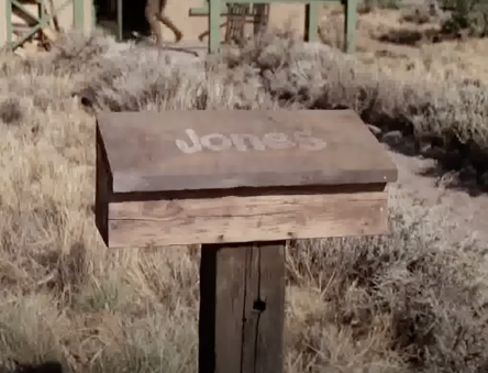 A wooden mailbox with the name "Jones" on it is seen outside a house in Antonito, CO.