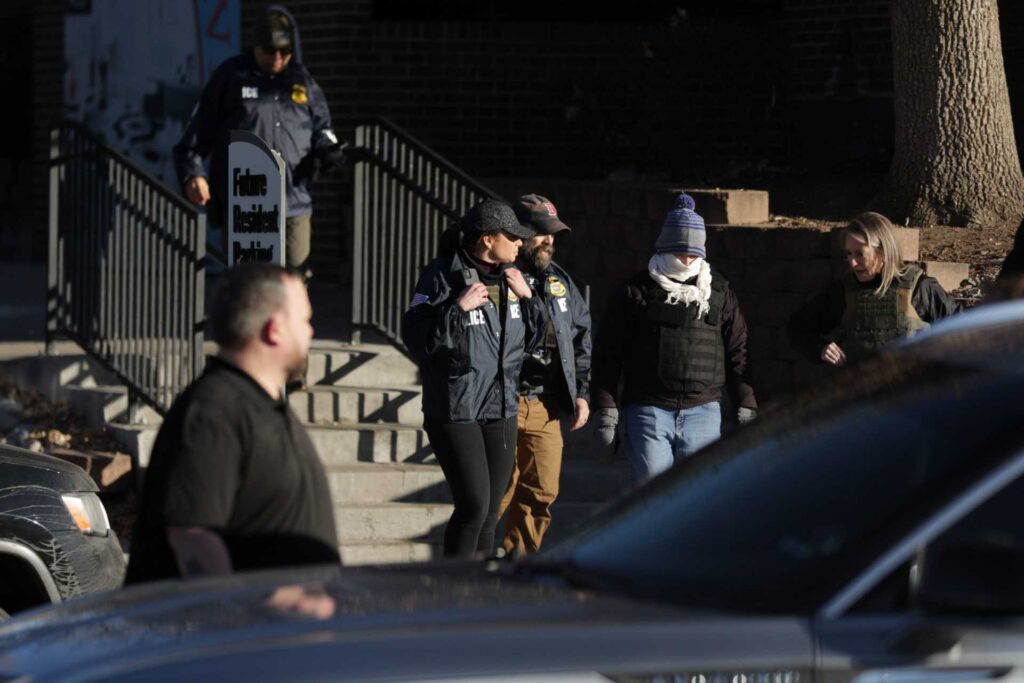 Federal law enforcement outside the Cedar Run Apartments