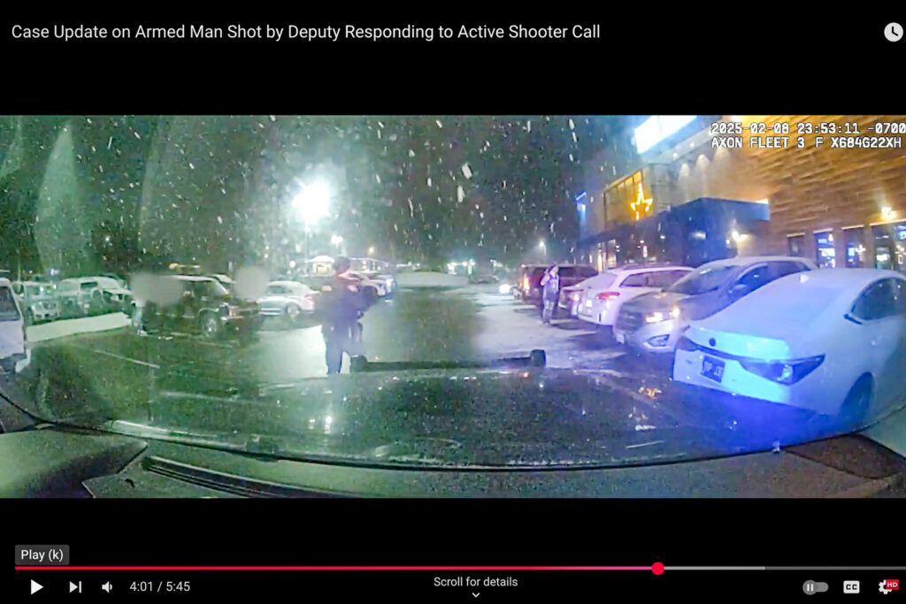 Video from a dashboard camera shows a Douglas County sheriff's deputy with a rifle approaching a young man holding an object in his right hand.