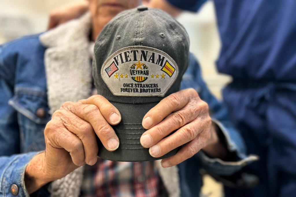 Vietnam Veteran Chester Reed of Colorado Springs holds his baseball cap