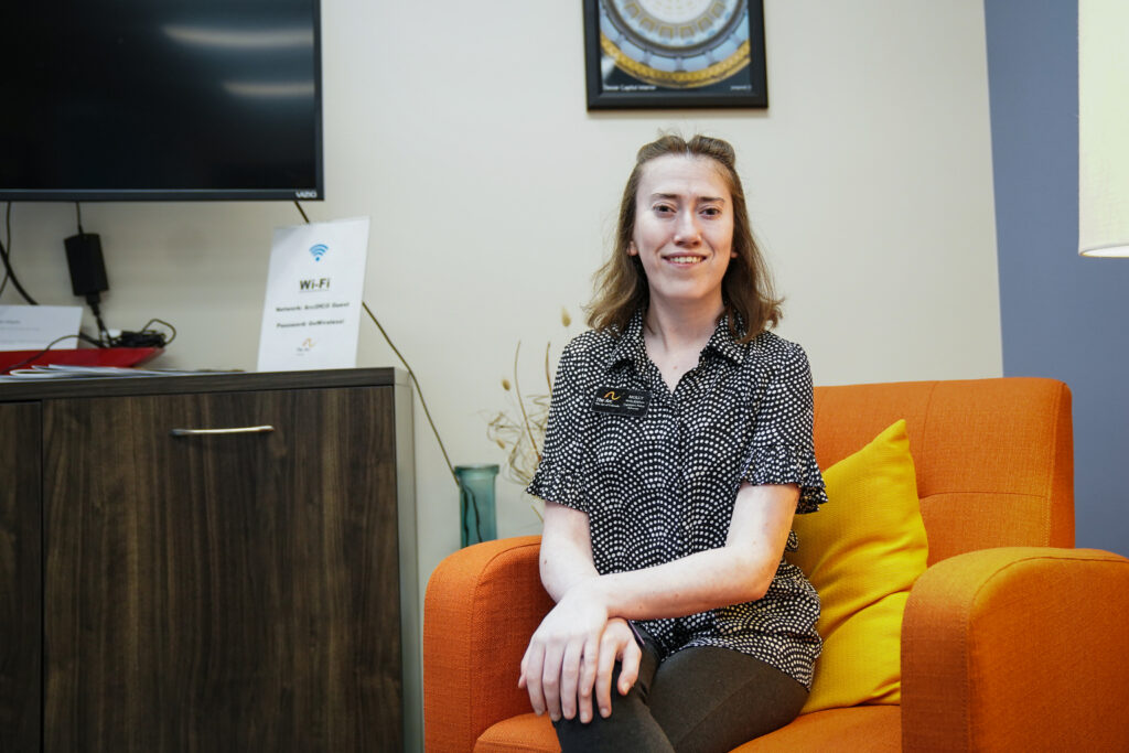 Portrait of Molly Kirkham on an office chair