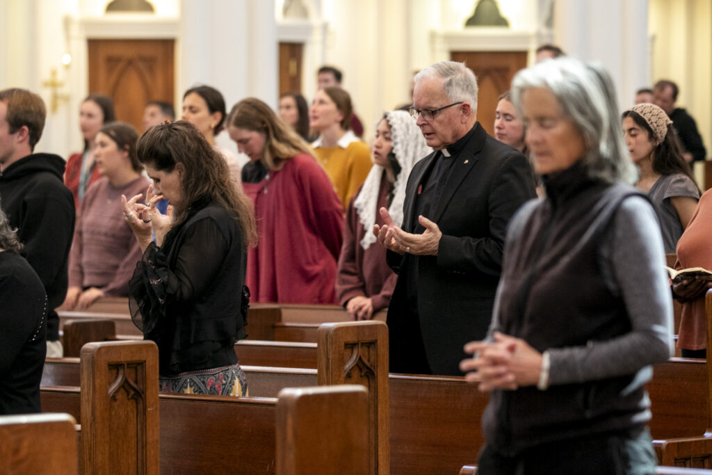 The congregation stands to pray