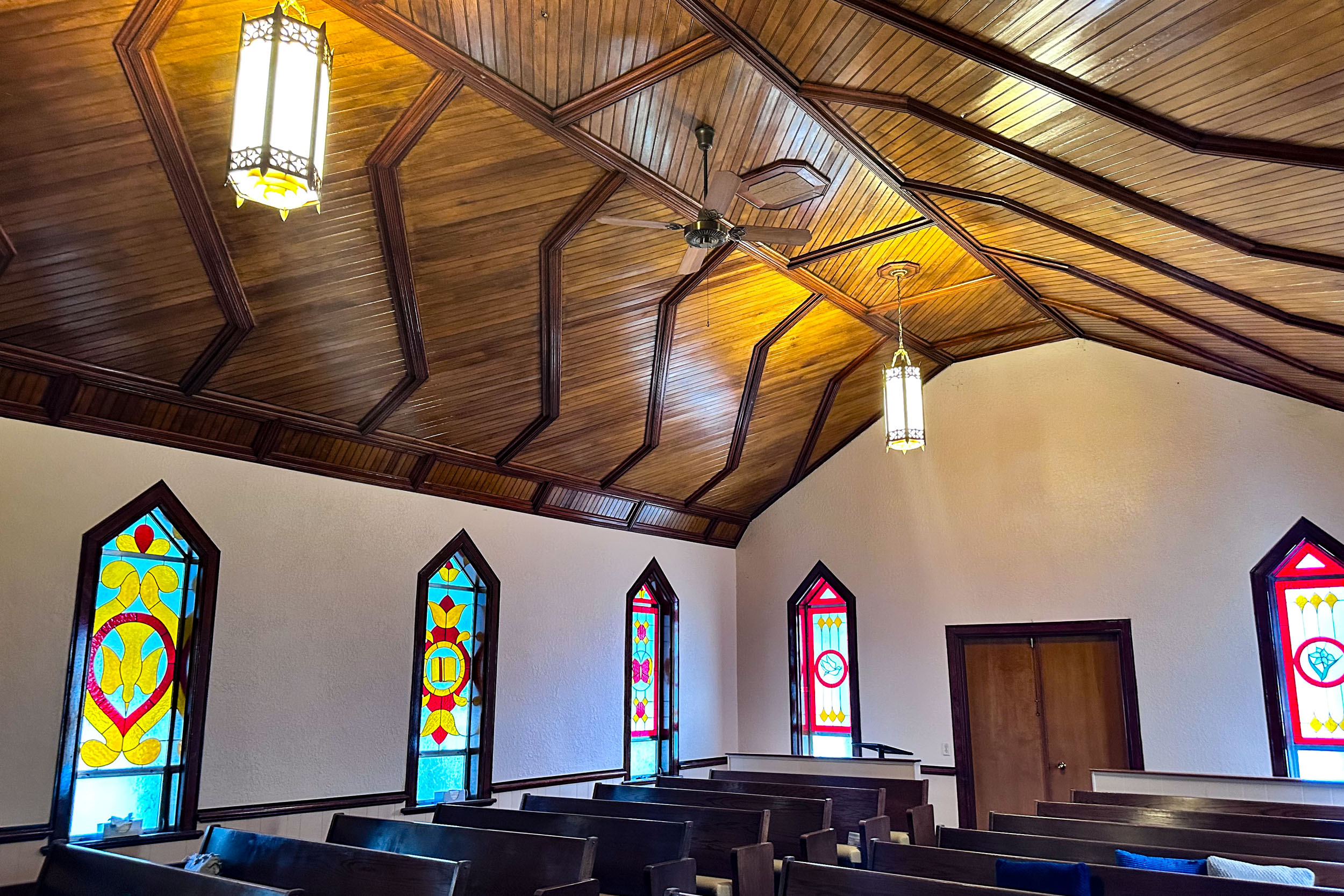 church interior with stained glass windows and pews