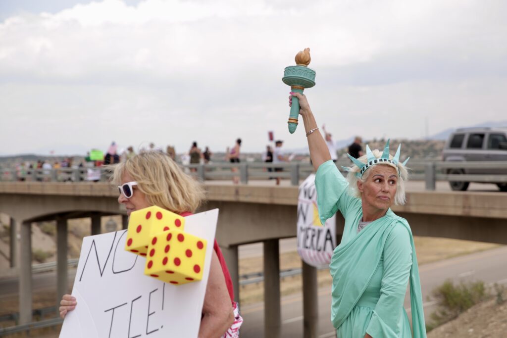 A woman dressed as the statue of liberty protests near a closed detention center in Huerfano County Colorado