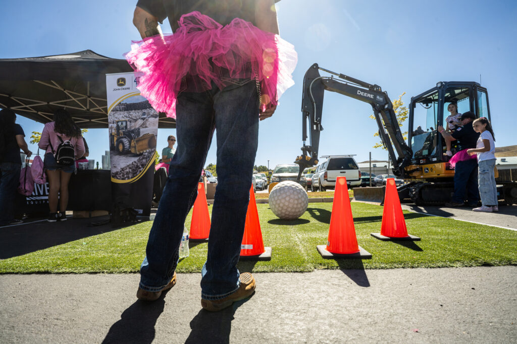 A man in blue jeans and a pink tutu