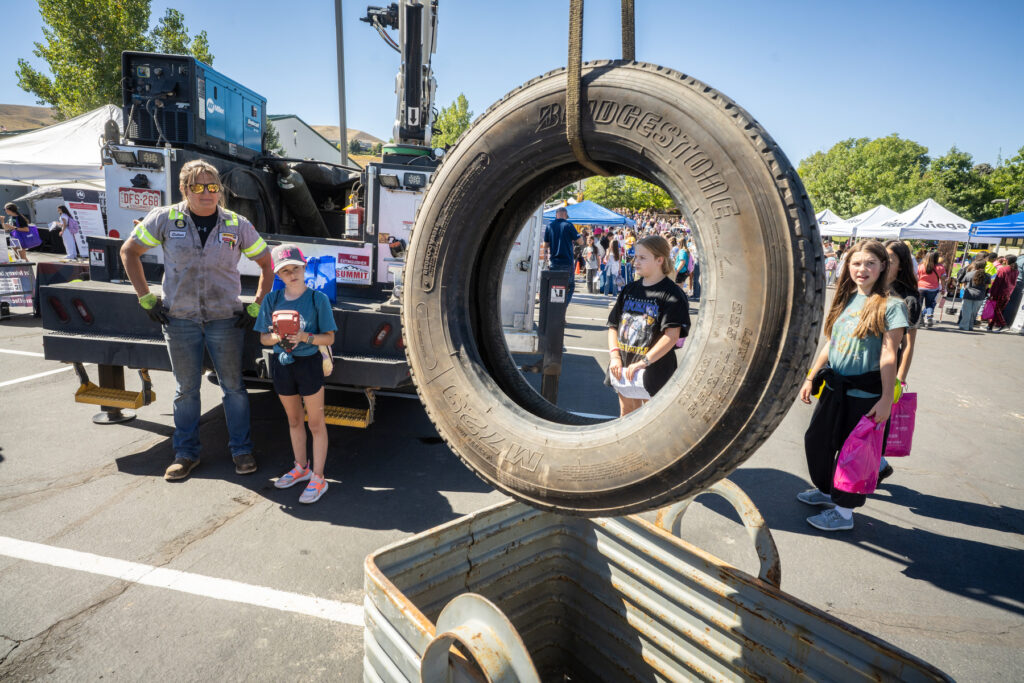Girls line up to use a tire hoist