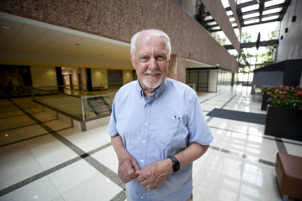 A man stands in an atrium.