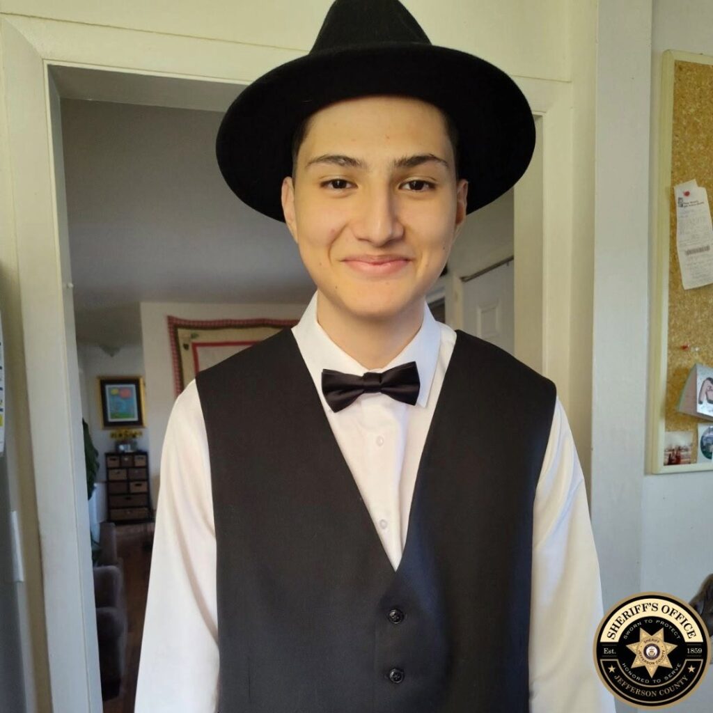 Young man with hat on and a vest and bowtie