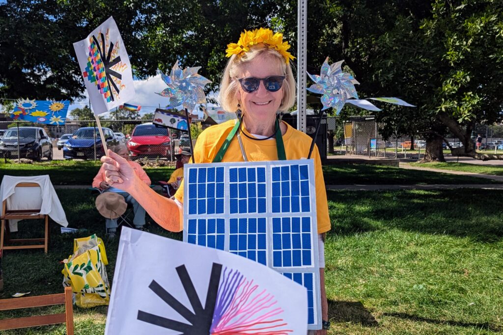 An organizer wears a solar panel costume at a Denver Sun Day event