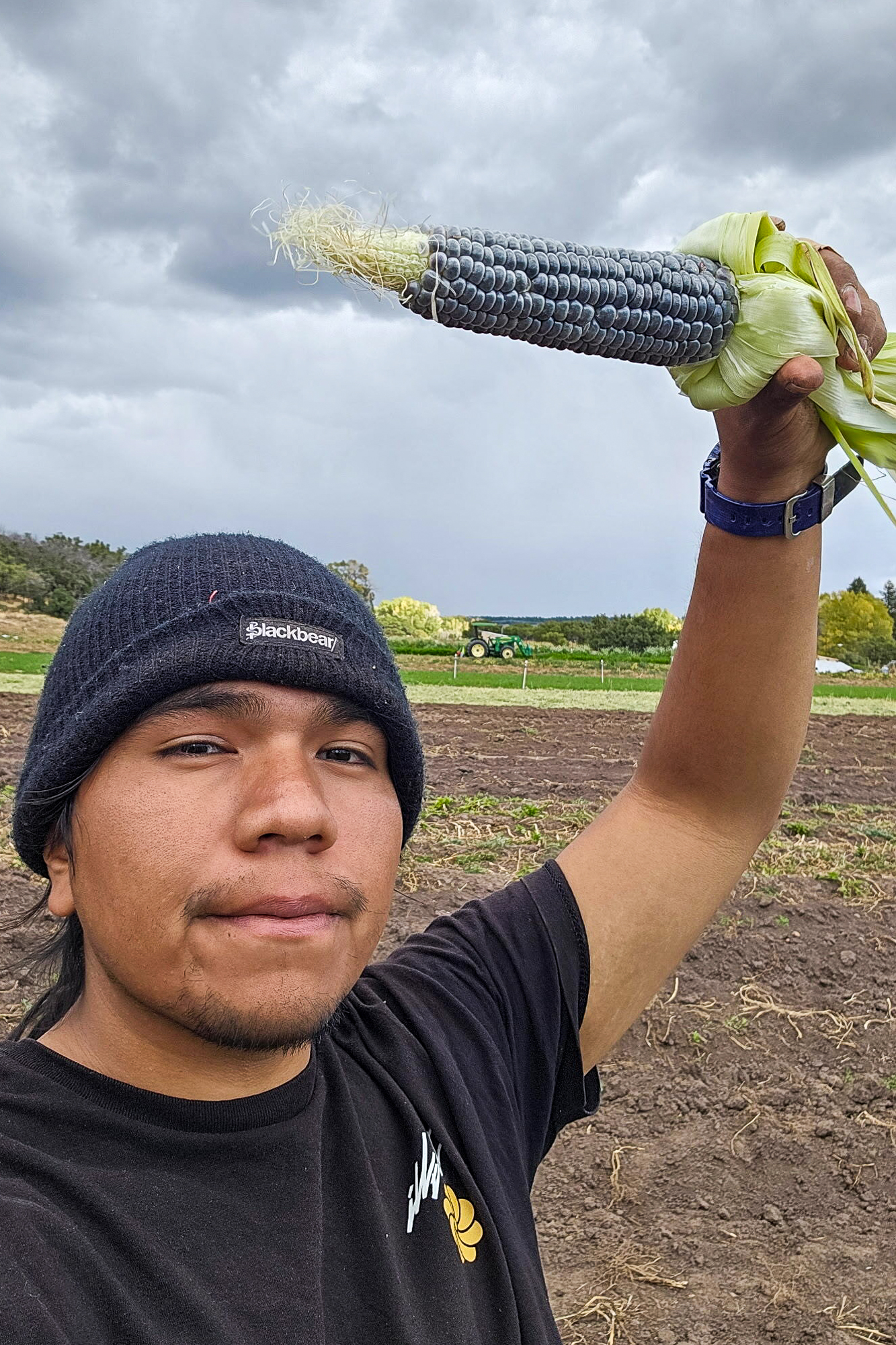 TeAndre McLane holds an ear of blue corn